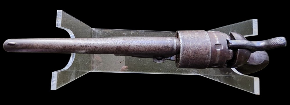 Side profile of a patinated steel Colt Model 1860 Army percussion revolver featuring a walnut handle grip and brass trigger guard. View XVII