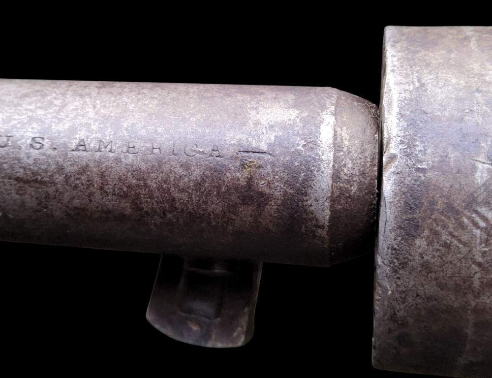 Side profile of a patinated steel Colt Model 1860 Army percussion revolver featuring a walnut handle grip and brass trigger guard. View XXIV