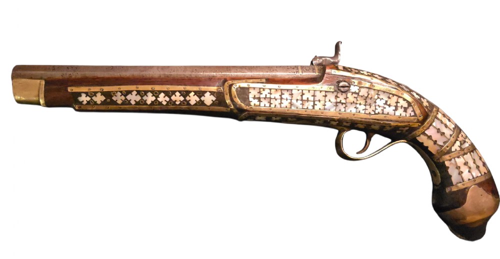 A 19th-century Ottoman pistol featuring a dark wood stock inlaid with mother-of-pearl geometric designs and brass wire, with an engraved steel mechanism and barrel. View II