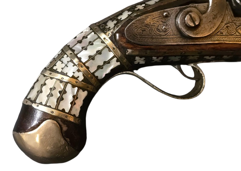 A 19th-century Ottoman pistol featuring a dark wood stock inlaid with mother-of-pearl geometric designs and brass wire, with an engraved steel mechanism and barrel. View VIII
