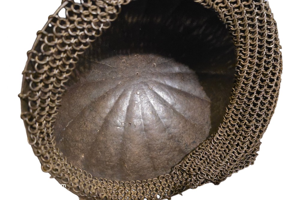 An 18th-century Indian steel Kulah Khud helmet featuring gold inlay detailing, a sliding nasal guard, a tall plume with white and green hair, and a hanging chainmail aventail. View X