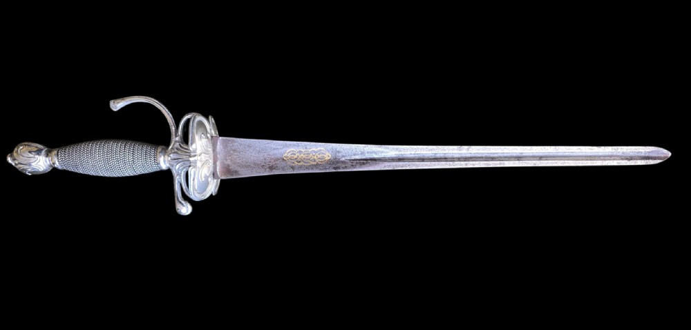 An 18th-century silver-hilted smallsword converted into a short sword or dagger, featuring a decorated silver hilt with wire-bound grip and a tapered steel blade. View VI