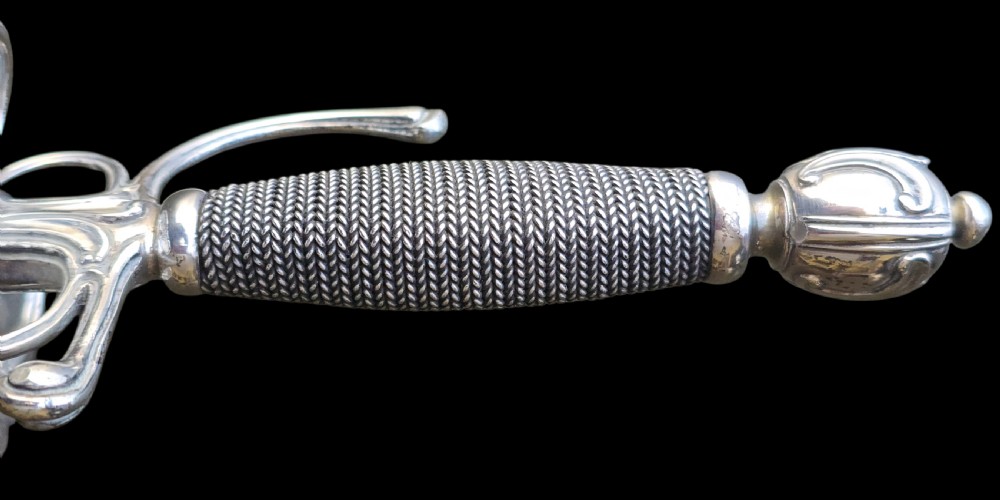 An 18th-century silver-hilted smallsword converted into a short sword or dagger, featuring a decorated silver hilt with wire-bound grip and a tapered steel blade. View IX