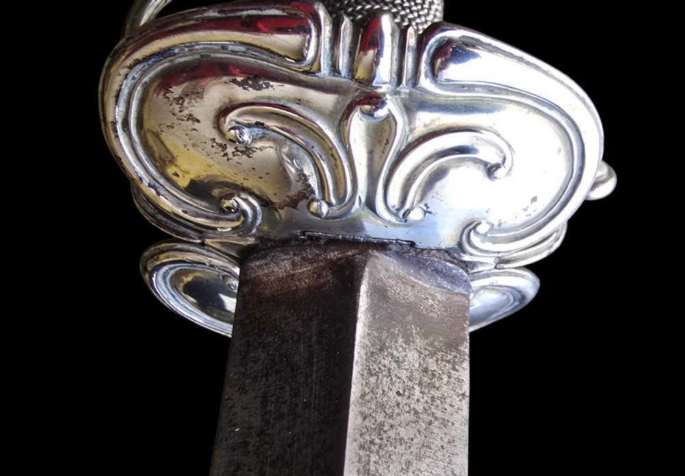 An 18th-century silver-hilted smallsword converted into a short sword or dagger, featuring a decorated silver hilt with wire-bound grip and a tapered steel blade. View XVIII