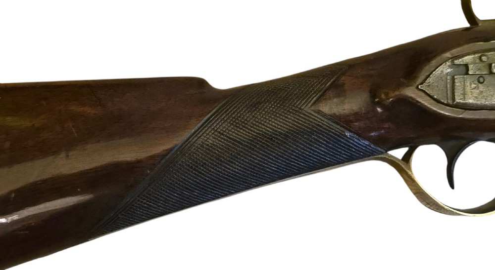 Late eighteenth-century British flintlock blunderbuss featuring a flared brass barrel, dark polished walnut stock, steel flintlock action, top-mounted sprung bayonet, and a separate wooden ramrod. View VI