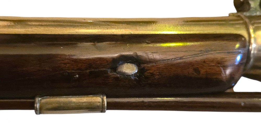 Late eighteenth-century British flintlock blunderbuss featuring a flared brass barrel, dark polished walnut stock, steel flintlock action, top-mounted sprung bayonet, and a separate wooden ramrod. View IX