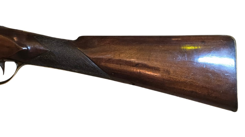 Late eighteenth-century British flintlock blunderbuss featuring a flared brass barrel, dark polished walnut stock, steel flintlock action, top-mounted sprung bayonet, and a separate wooden ramrod. View XI