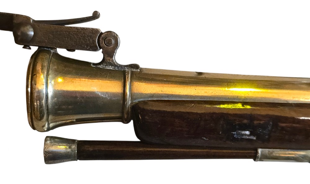 Late eighteenth-century British flintlock blunderbuss featuring a flared brass barrel, dark polished walnut stock, steel flintlock action, top-mounted sprung bayonet, and a separate wooden ramrod. View XIV