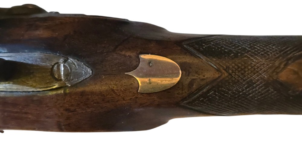 Late eighteenth-century British flintlock blunderbuss featuring a flared brass barrel, dark polished walnut stock, steel flintlock action, top-mounted sprung bayonet, and a separate wooden ramrod. View XXIII
