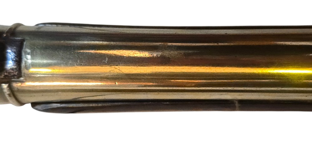 Late eighteenth-century British flintlock blunderbuss featuring a flared brass barrel, dark polished walnut stock, steel flintlock action, top-mounted sprung bayonet, and a separate wooden ramrod. View XXVI