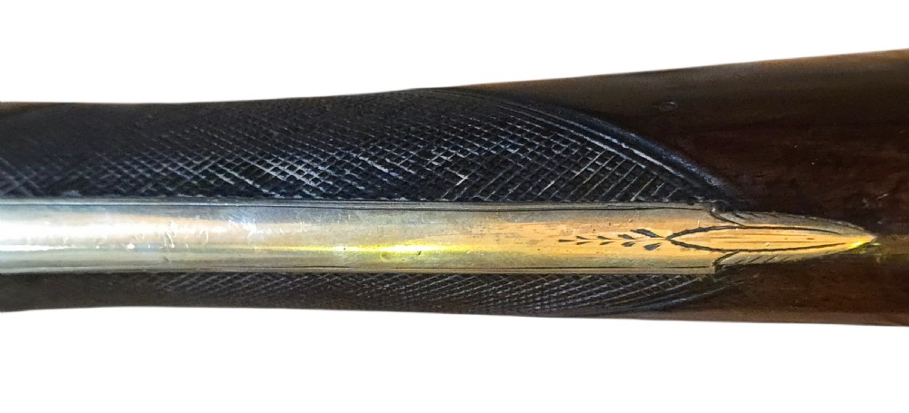 Late eighteenth-century British flintlock blunderbuss featuring a flared brass barrel, dark polished walnut stock, steel flintlock action, top-mounted sprung bayonet, and a separate wooden ramrod. View XXIX
