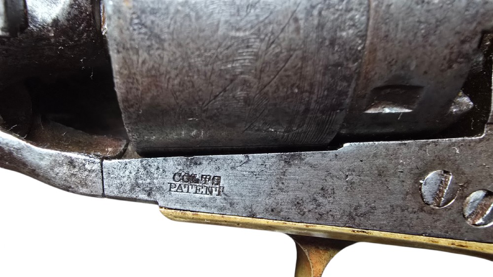 A 19th-century Colt Model 1860 Army percussion revolver featuring a steel barrel, creeping lever mechanism, brass trigger guard, and dark walnut grip. View IX
