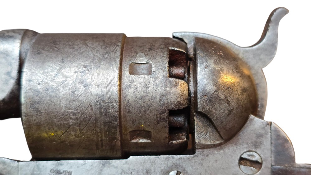 A 19th-century Colt Model 1860 Army percussion revolver featuring a steel barrel, creeping lever mechanism, brass trigger guard, and dark walnut grip. View XXIV