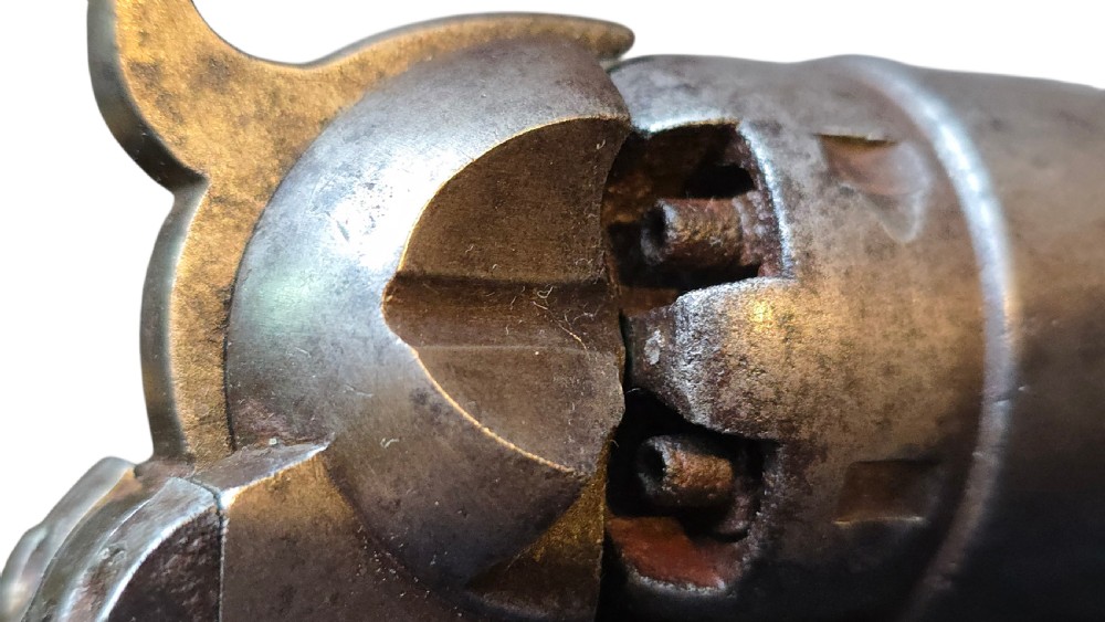 A 19th-century Colt Model 1860 Army percussion revolver featuring a steel barrel, creeping lever mechanism, brass trigger guard, and dark walnut grip. View XXV