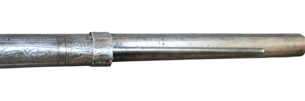 An eighteenth-century Ottoman Balkan flintlock musket carbine with a brass-sheathed stock featuring chased geometric patterns and a steel barrel. View X