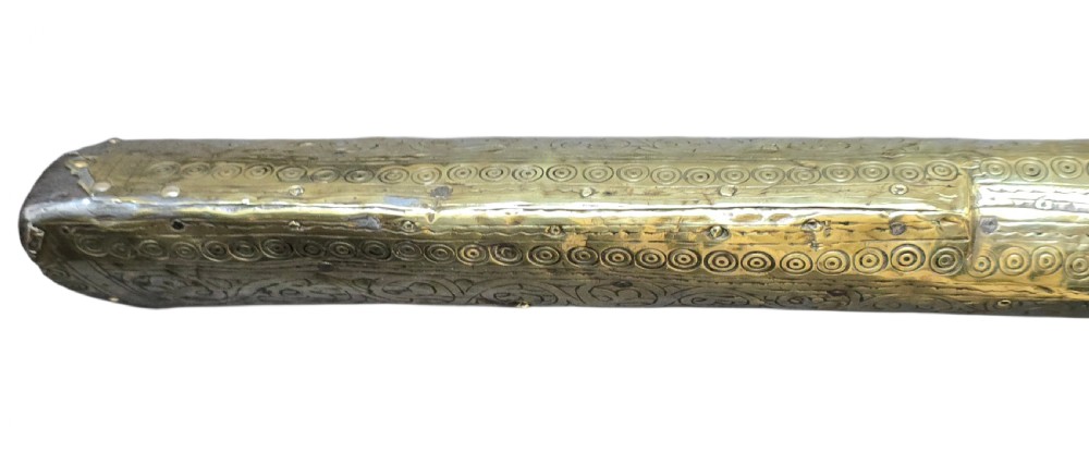 An eighteenth-century Ottoman Balkan flintlock musket carbine with a brass-sheathed stock featuring chased geometric patterns and a steel barrel. View XI