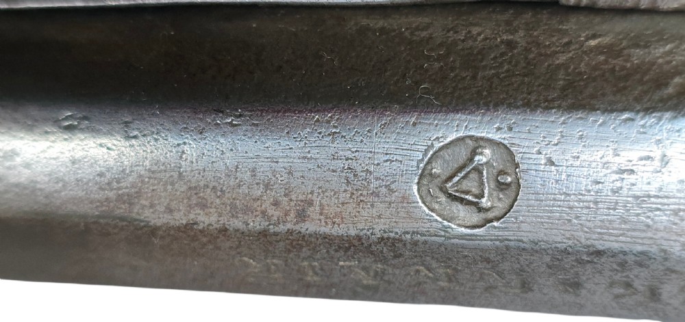 An eighteenth-century Ottoman Balkan flintlock musket carbine with a brass-sheathed stock featuring chased geometric patterns and a steel barrel. View XIII