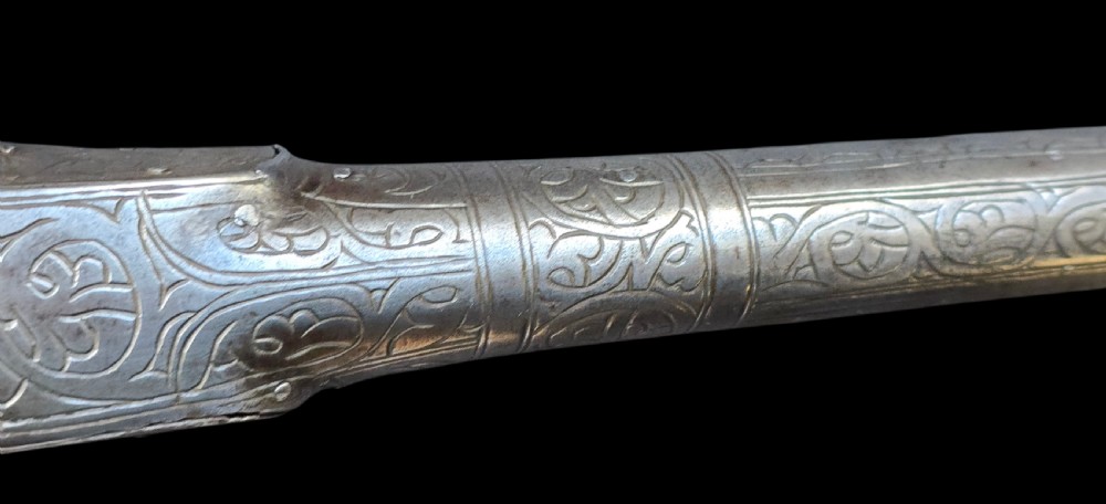 An eighteenth-century Ottoman Balkan flintlock musket carbine with a brass-sheathed stock featuring chased geometric patterns and a steel barrel. View XVIII