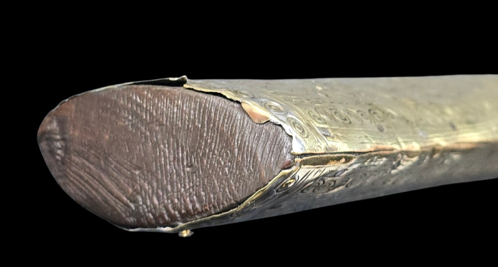 An eighteenth-century Ottoman Balkan flintlock musket carbine with a brass-sheathed stock featuring chased geometric patterns and a steel barrel. View XIX