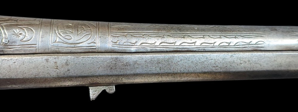 An eighteenth-century Ottoman Balkan flintlock musket carbine with a brass-sheathed stock featuring chased geometric patterns and a steel barrel. View XXI