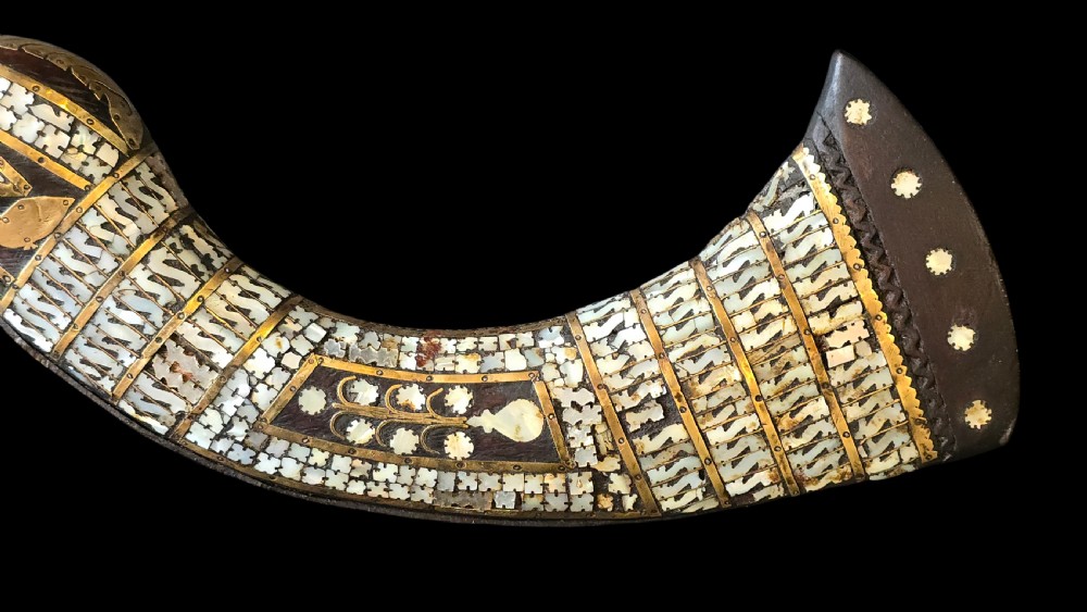 A late 18th-century Indo-Persian flintlock musket featuring a curved wooden stock inlaid with mother-of-pearl geometric patterns and bound with brass barrel bands. View V
