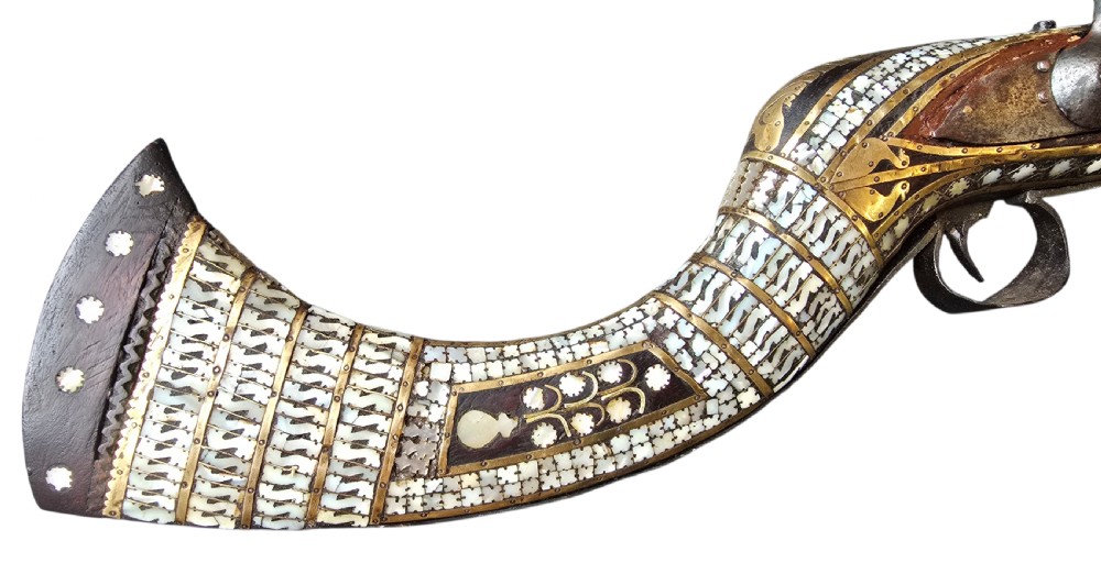 A late 18th-century Indo-Persian flintlock musket featuring a curved wooden stock inlaid with mother-of-pearl geometric patterns and bound with brass barrel bands. View VIII