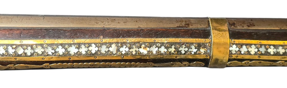 A late 18th-century Indo-Persian flintlock musket featuring a curved wooden stock inlaid with mother-of-pearl geometric patterns and bound with brass barrel bands. View XI