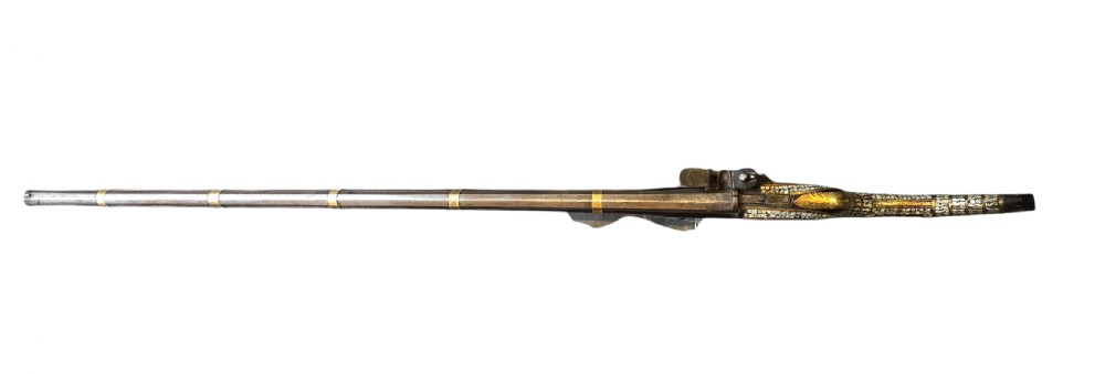 A late 18th-century Indo-Persian flintlock musket featuring a curved wooden stock inlaid with mother-of-pearl geometric patterns and bound with brass barrel bands. View XXIII