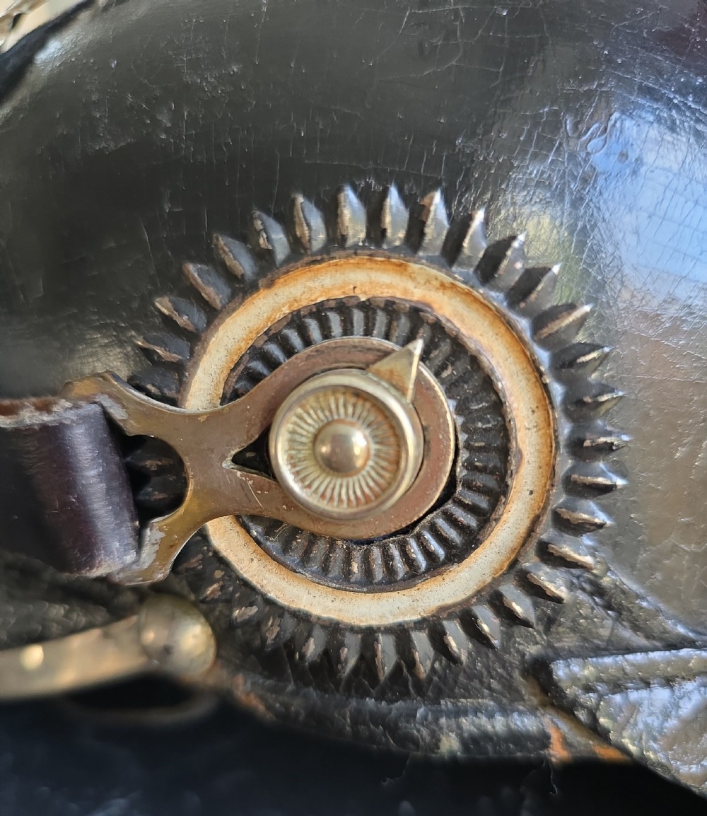 A black lacquered leather Imperial German Pickelhaube helmet featuring a tall silver metal spike and a prominent Prussian eagle front plate. View IX