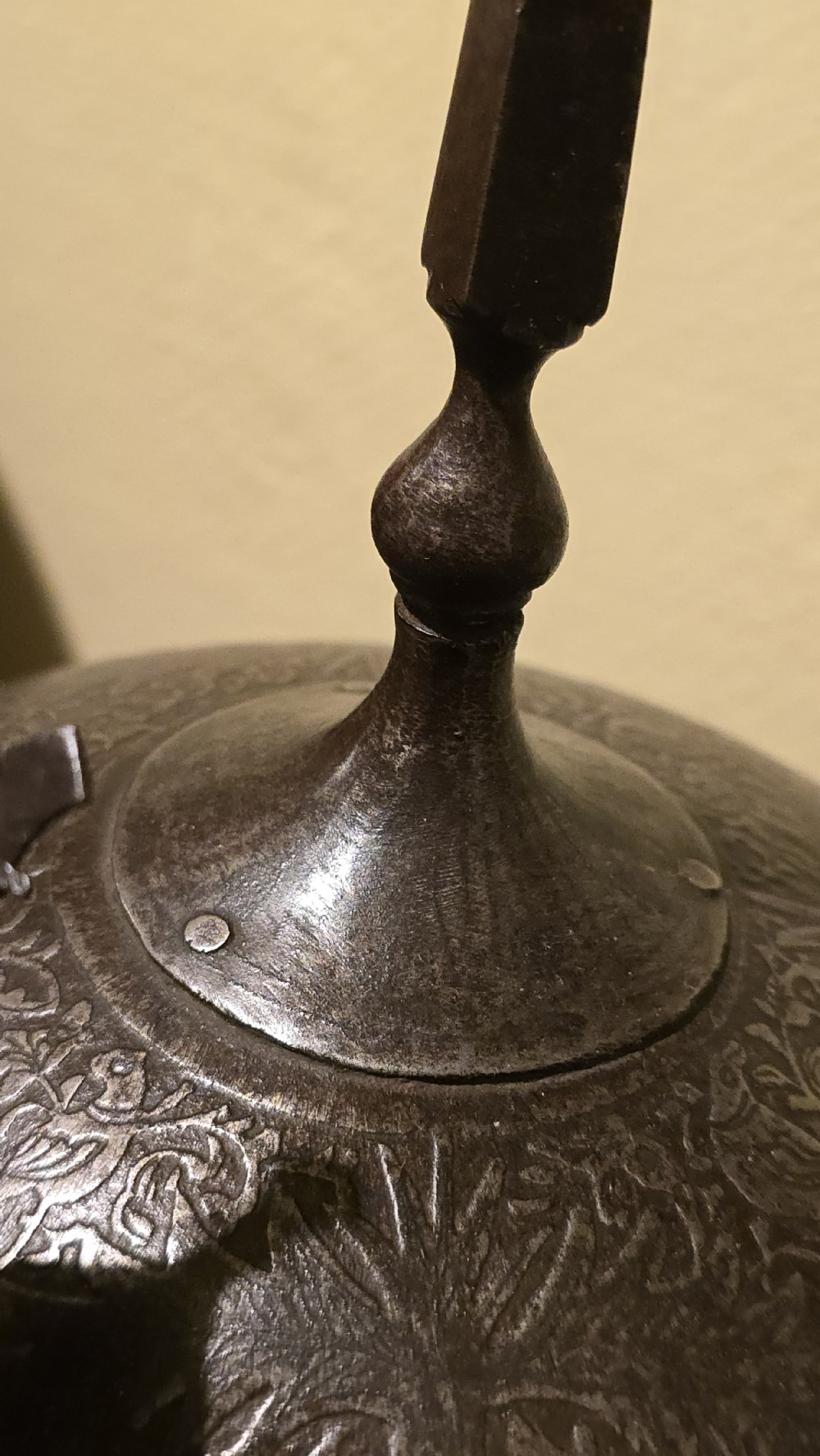 An antique steel Indo-Persian Kullah Khud helmet featuring a central top spike, engraved calligraphic rim, sliding nasal guard, and hanging chainmail aventail mounted on a display stand. View XIII
