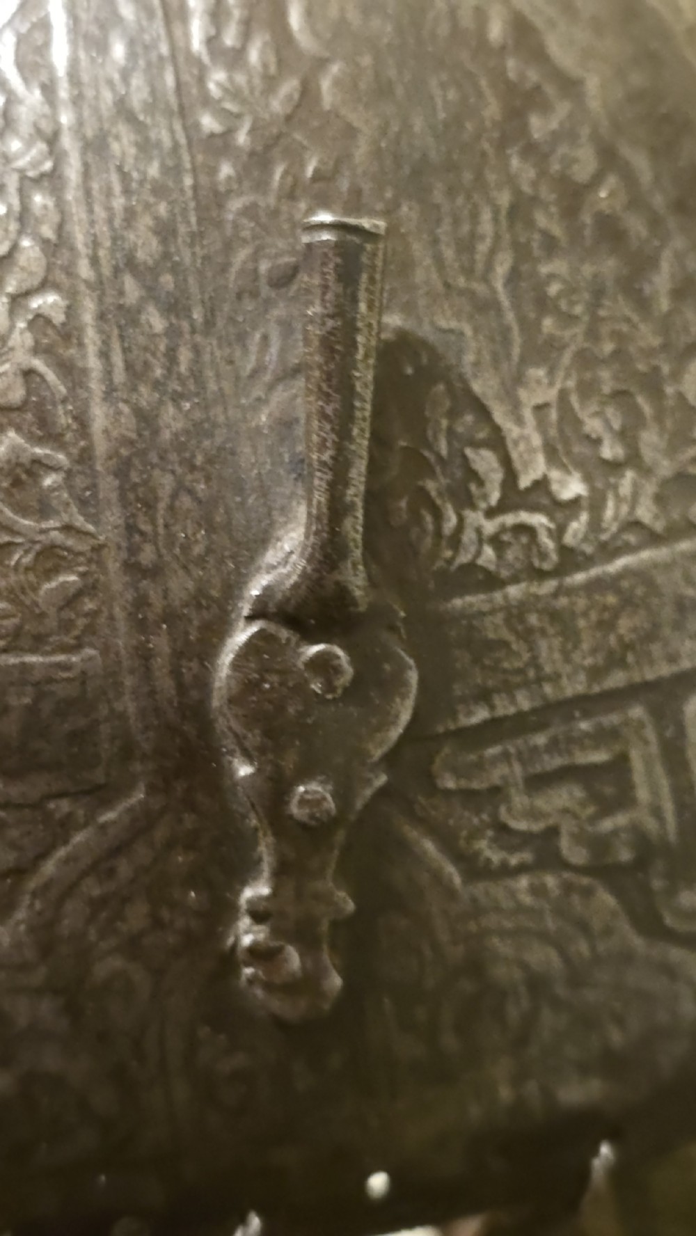 An antique steel Indo-Persian Kullah Khud helmet featuring a central top spike, engraved calligraphic rim, sliding nasal guard, and hanging chainmail aventail mounted on a display stand. View XIV