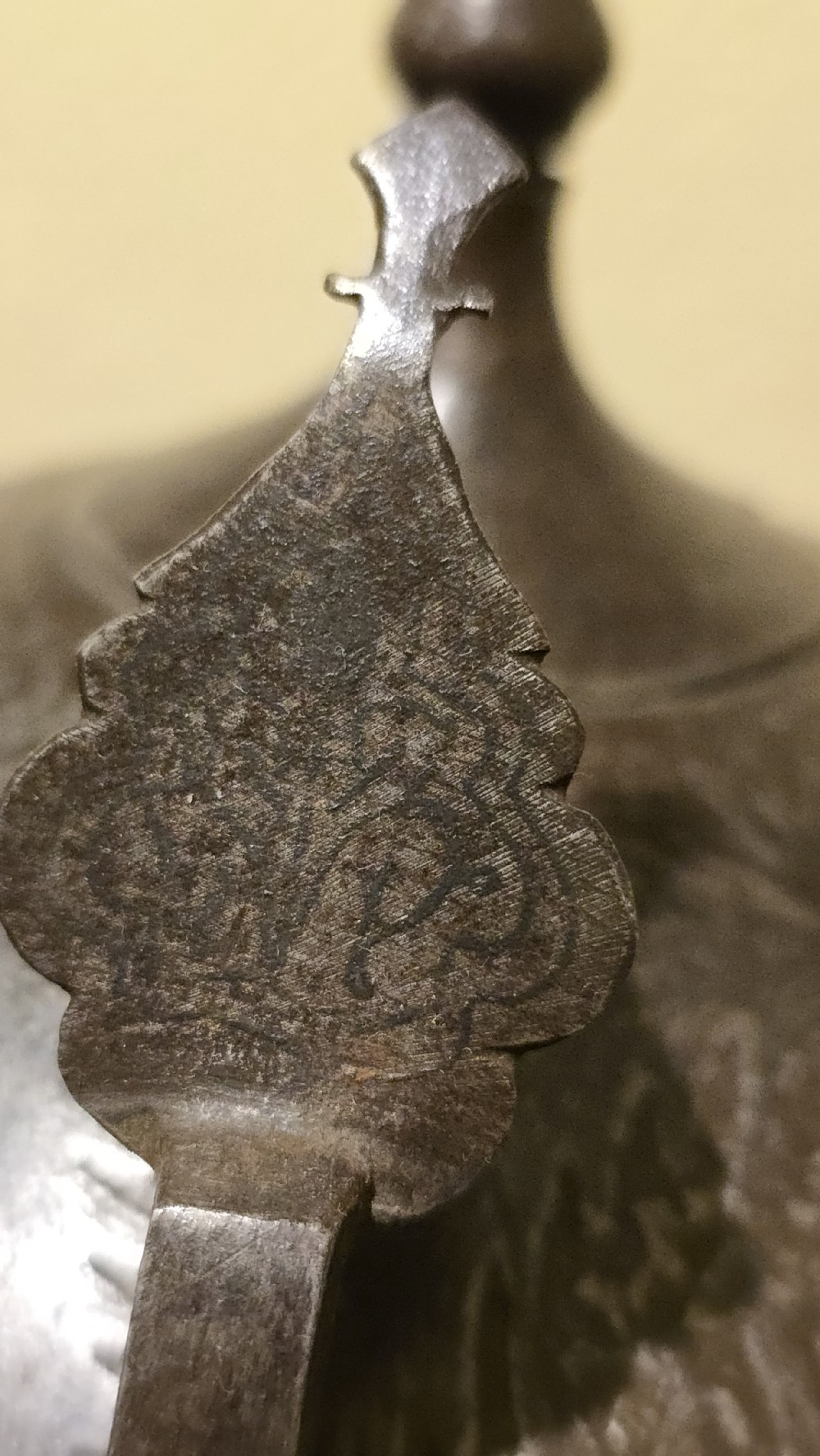 An antique steel Indo-Persian Kullah Khud helmet featuring a central top spike, engraved calligraphic rim, sliding nasal guard, and hanging chainmail aventail mounted on a display stand. View XVI