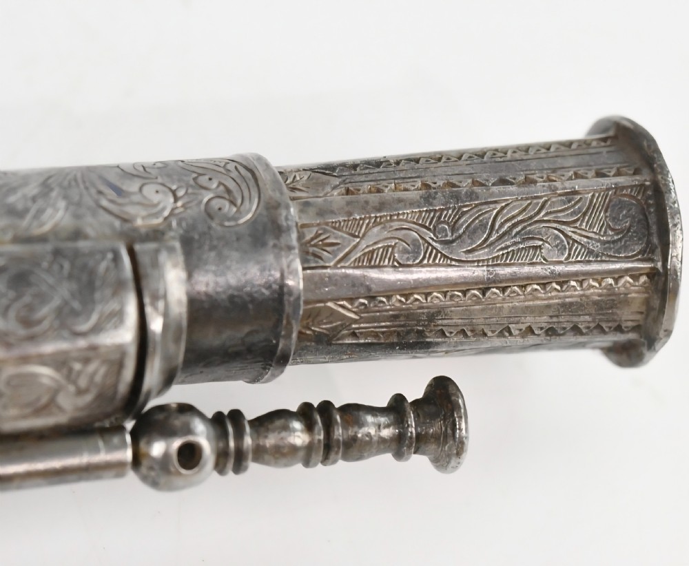 An 18th-century Scottish all-steel scroll-butt flintlock pistol with intricate surface engravings and a ramshorn terminal. View V
