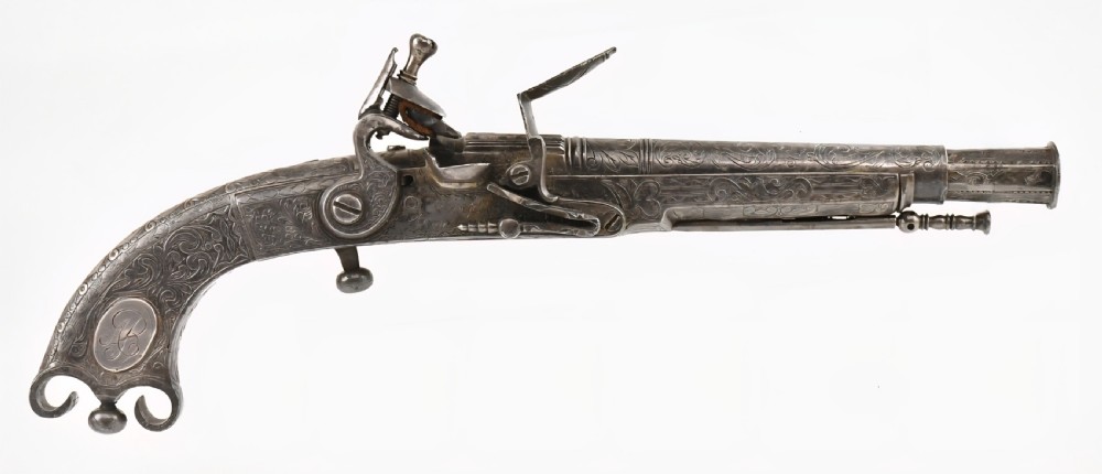 An 18th-century Scottish all-steel scroll-butt flintlock pistol with intricate surface engravings and a ramshorn terminal. View XVI