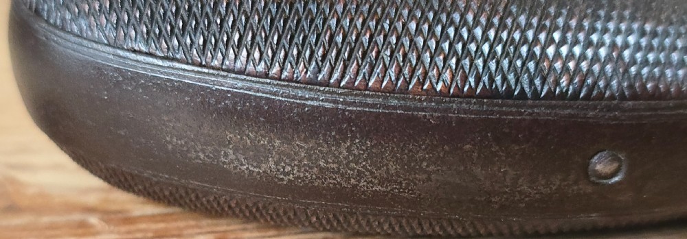 A nineteenth-century six-shot percussion pepperbox pistol featuring a multi-barrel steel cylinder, engraved frame, ring trigger, and chequered dark wood grip. View XXII