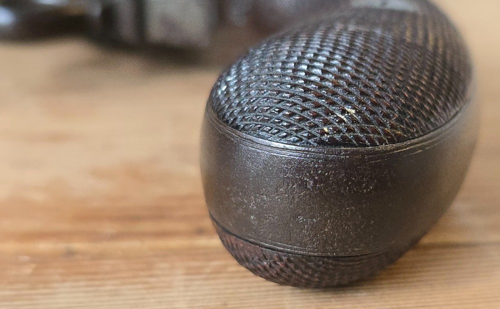 A nineteenth-century six-shot percussion pepperbox pistol featuring a multi-barrel steel cylinder, engraved frame, ring trigger, and chequered dark wood grip. View XXIII