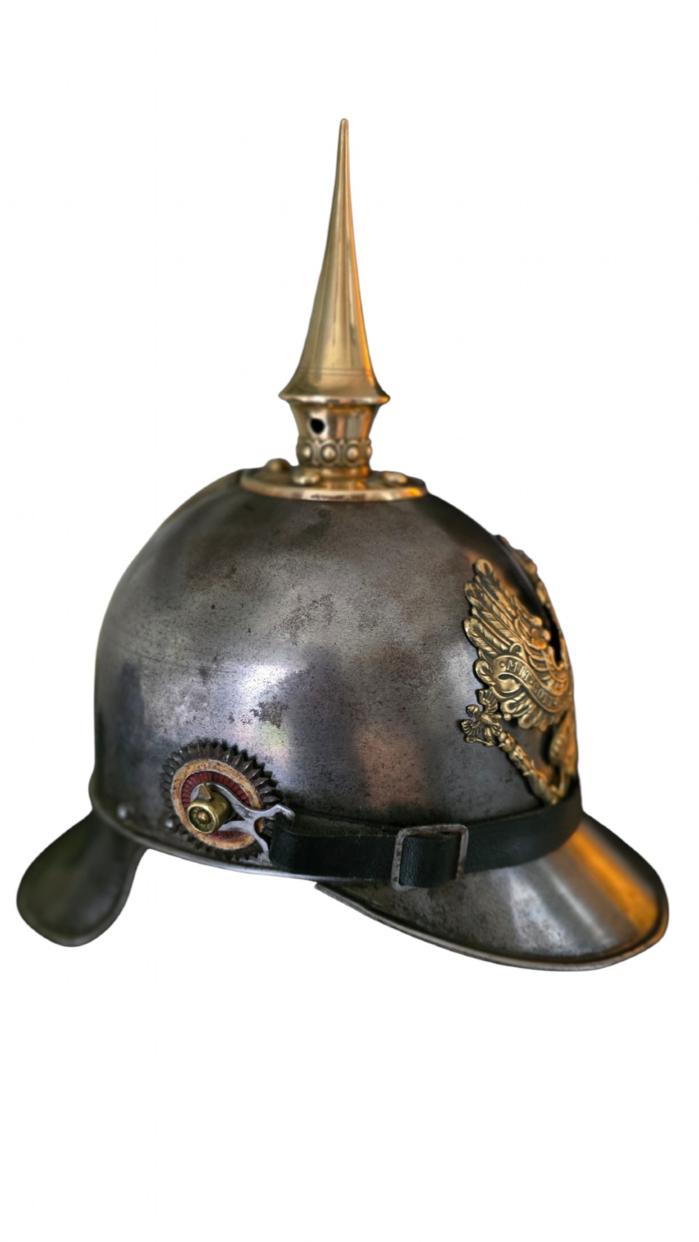 A WWI Prussian steel Pickelhaube helmet featuring a brass spiked top, a brass Prussian eagle emblem on the front, and a black strap. View II