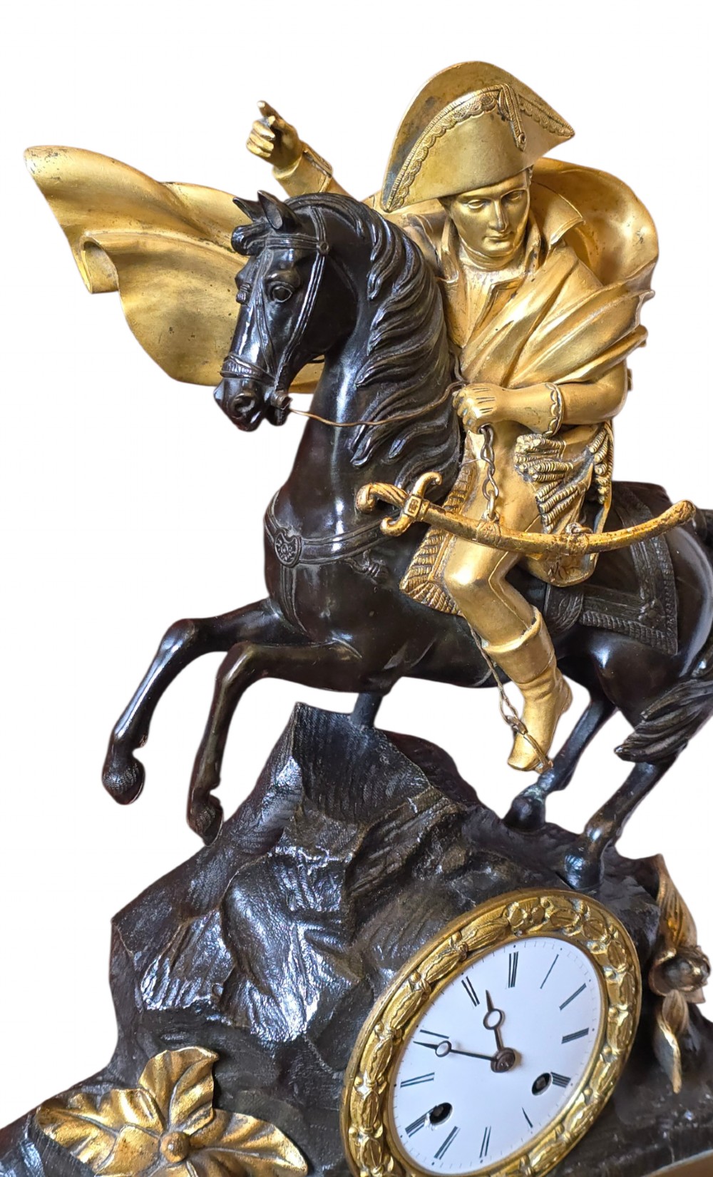 A 19th-century French mantel clock featuring a patinated and gilt bronze equestrian statue of Napoleon Bonaparte atop a base housing a white clock face with Roman numerals. View II