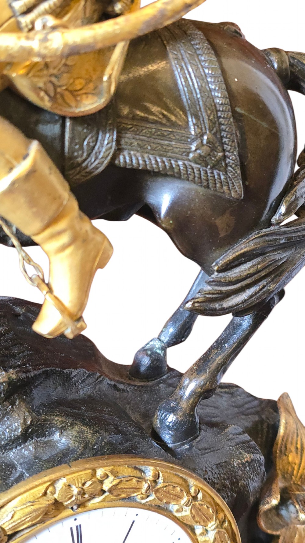 A 19th-century French mantel clock featuring a patinated and gilt bronze equestrian statue of Napoleon Bonaparte atop a base housing a white clock face with Roman numerals. View III