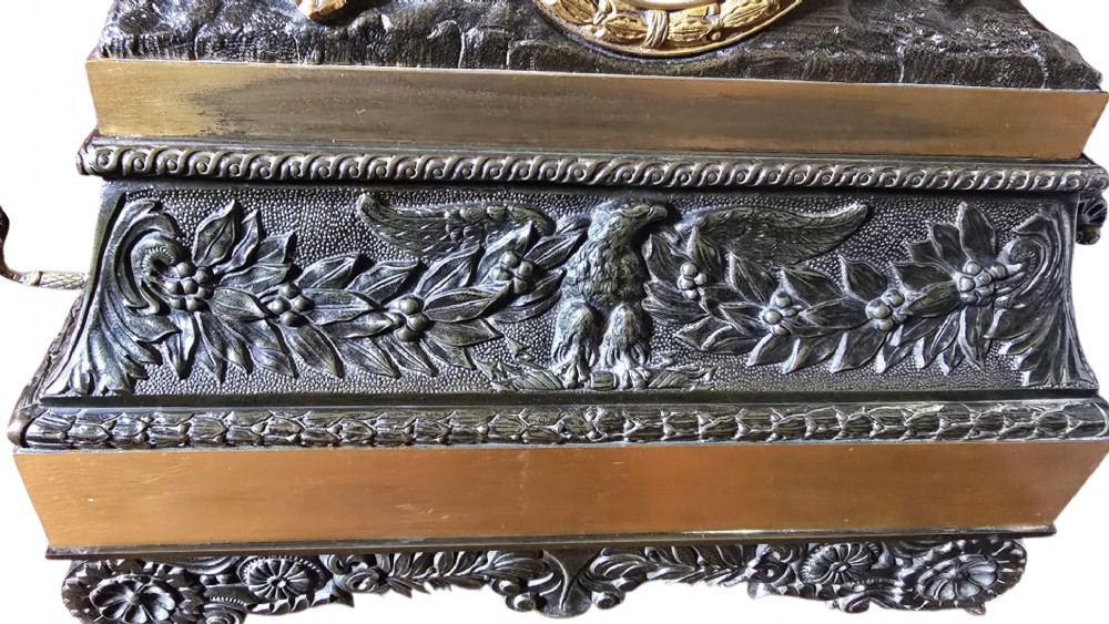 A 19th-century French mantel clock featuring a patinated and gilt bronze equestrian statue of Napoleon Bonaparte atop a base housing a white clock face with Roman numerals. View V