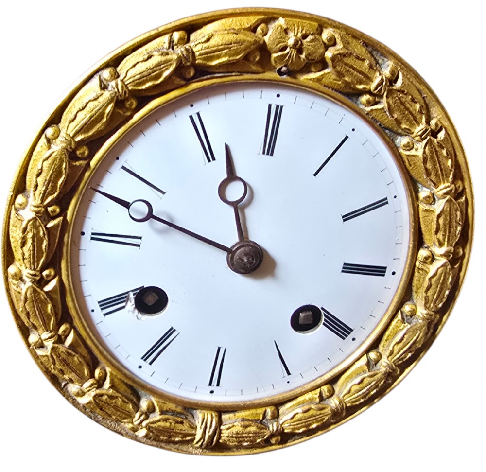 A 19th-century French mantel clock featuring a patinated and gilt bronze equestrian statue of Napoleon Bonaparte atop a base housing a white clock face with Roman numerals. View XI