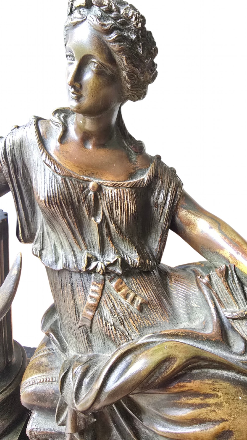 A 19th-century patinated bronze sculpture depicting the classical goddess Demeter seated beside a fluted column on a black stepped plinth. View IX