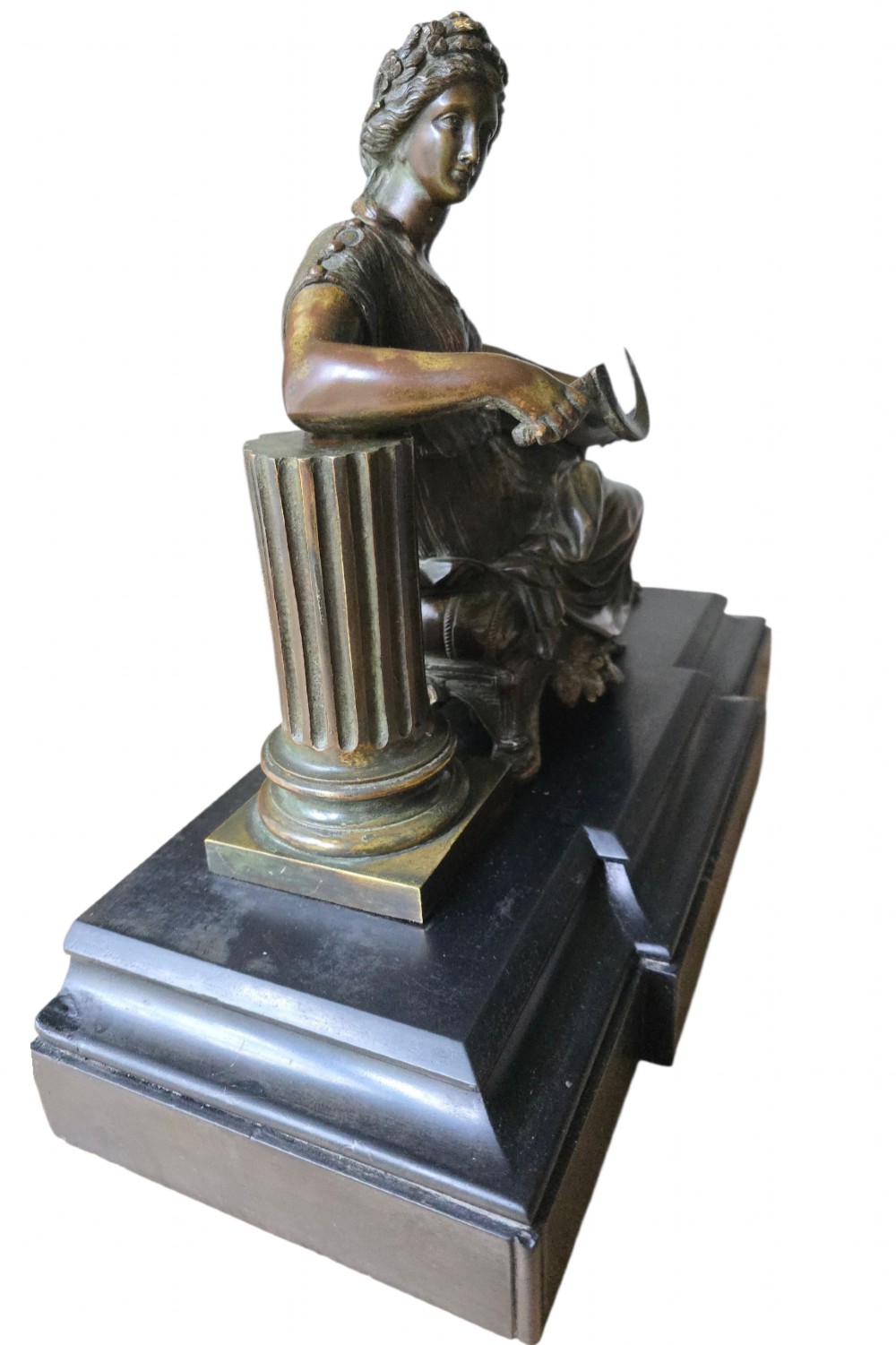 A 19th-century patinated bronze sculpture depicting the classical goddess Demeter seated beside a fluted column on a black stepped plinth. View XI