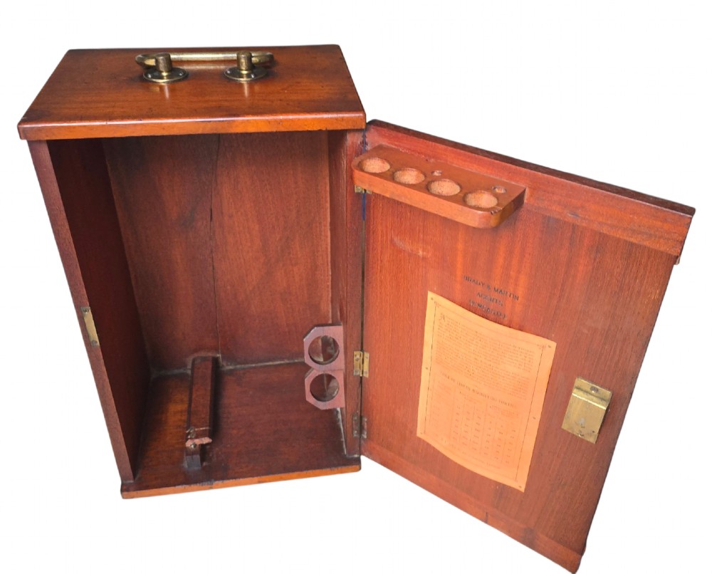 A Victorian lacquered brass binocular microscope featuring dual body tubes, knurled adjusting wheels, a stage plate, and a solid brass tripod foot. View XI