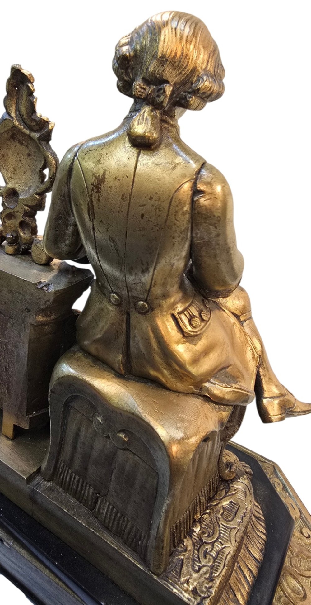 A 19th-century French gilt bronze sculpture depicting a seated gentleman in historic dress holding a quill, supported by an ornate black base with metallic scroll feet. View X