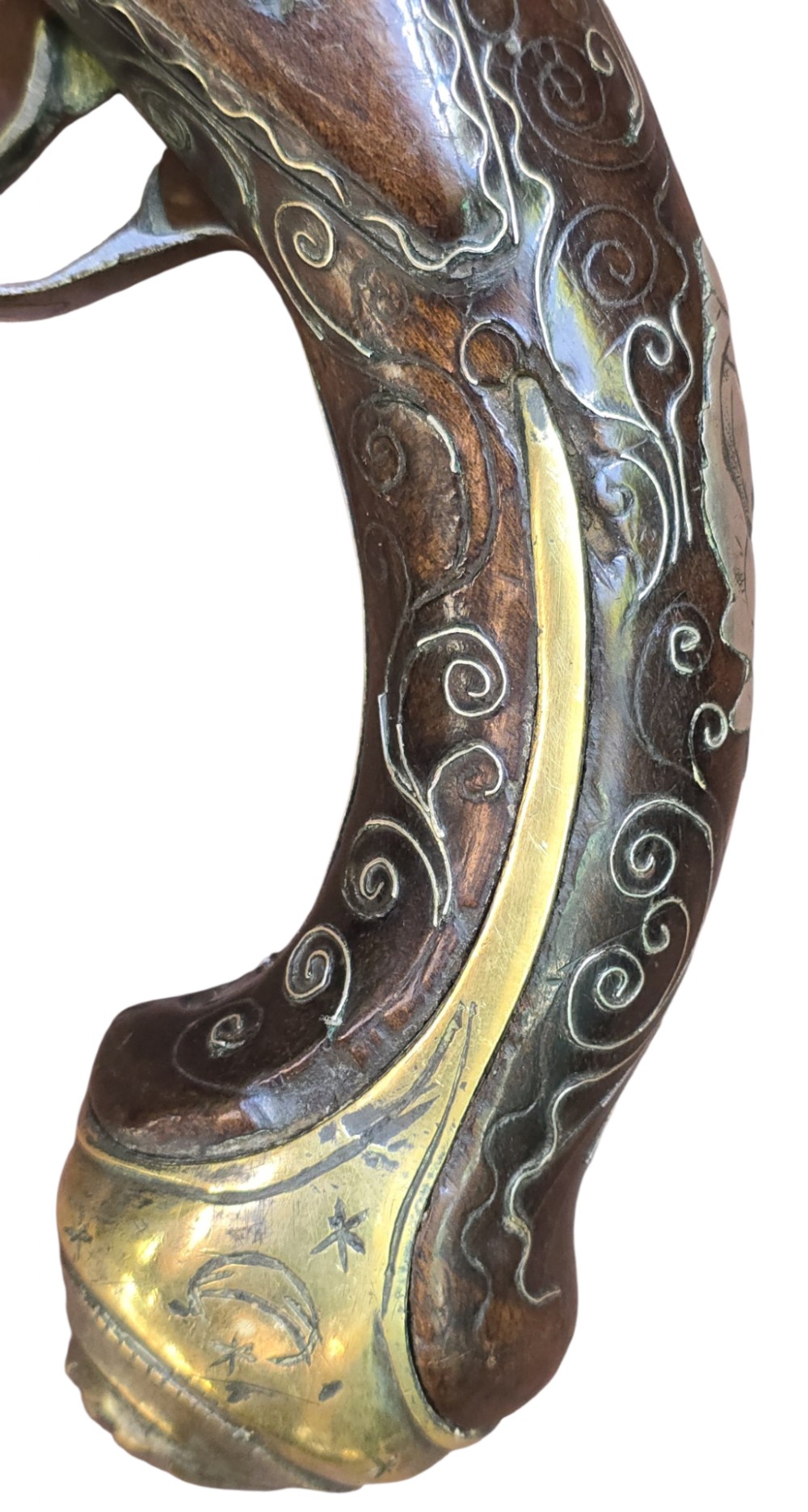 An early 19th-century Ottoman Balkan flintlock holster pistol featuring a dark wood stock inlaid with silver wire scrollwork and a cast brass pommel. View VIII