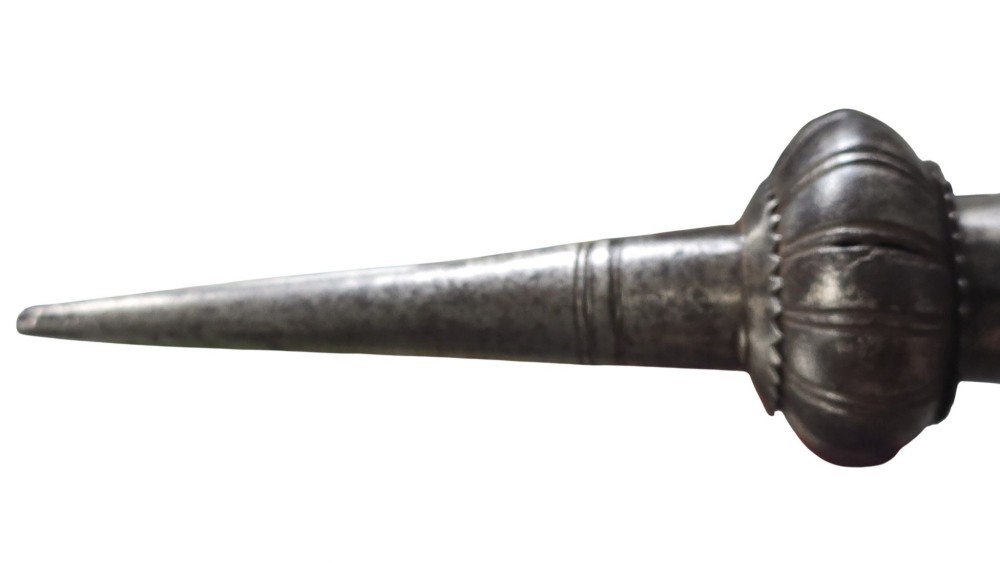 A 17th-century forged iron spear butt with a tapered spike and two ribbed knops, mounted vertically on a dark square stand. View VIII