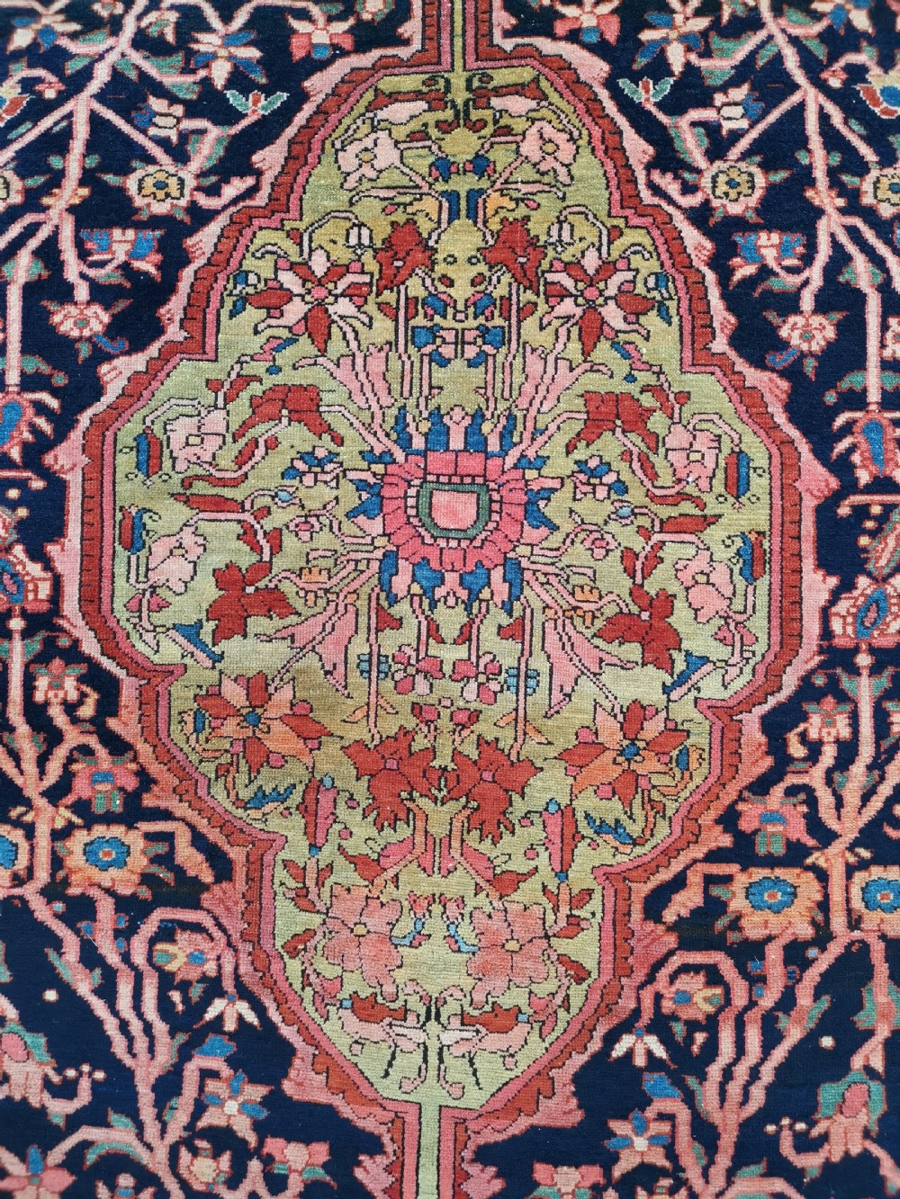 A hand-knotted antique Persian Mishan Malayer wool rug with a navy blue field, central olive medallion, and rose pink floral borders. View II