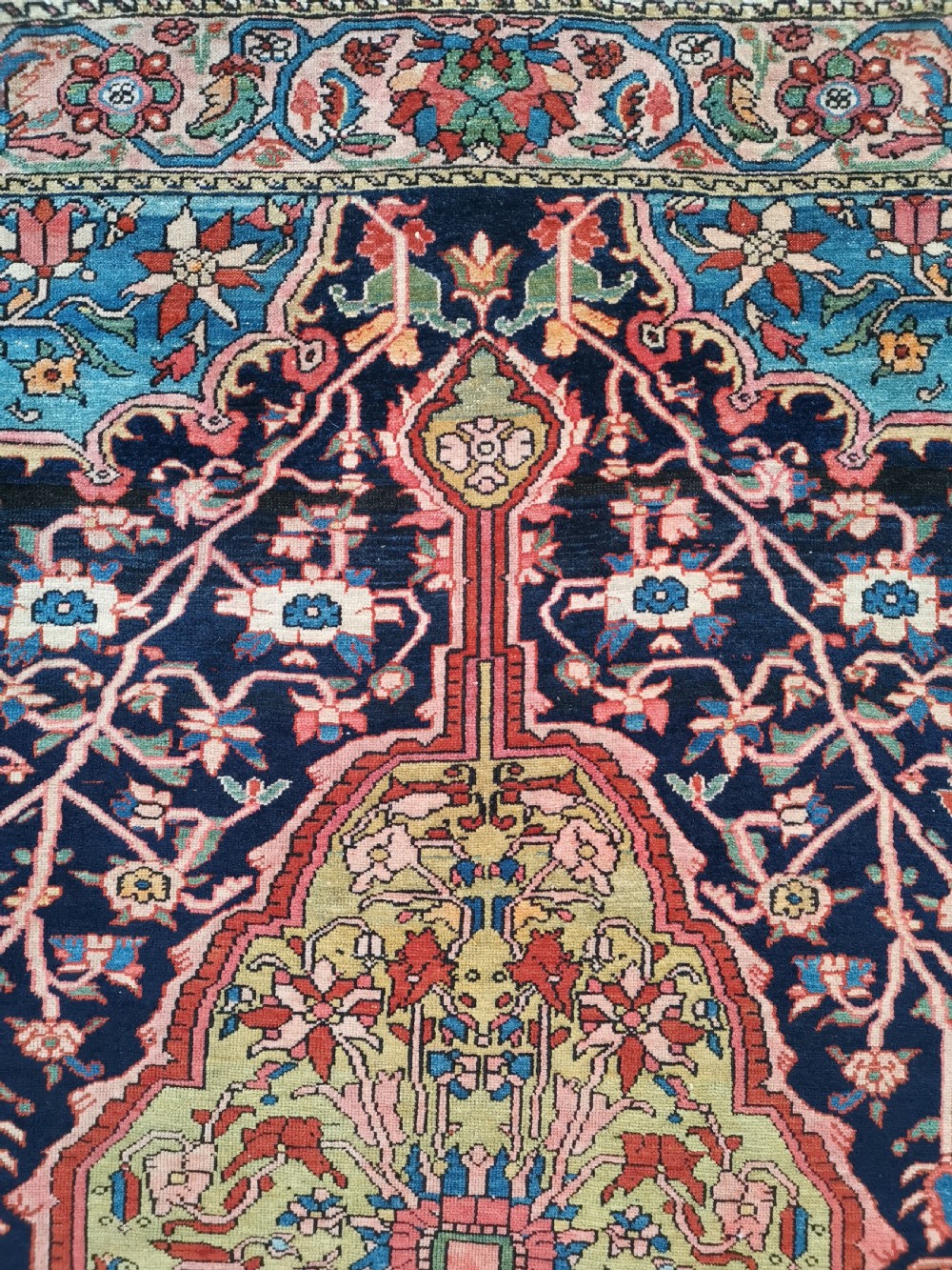 A hand-knotted antique Persian Mishan Malayer wool rug with a navy blue field, central olive medallion, and rose pink floral borders. View III