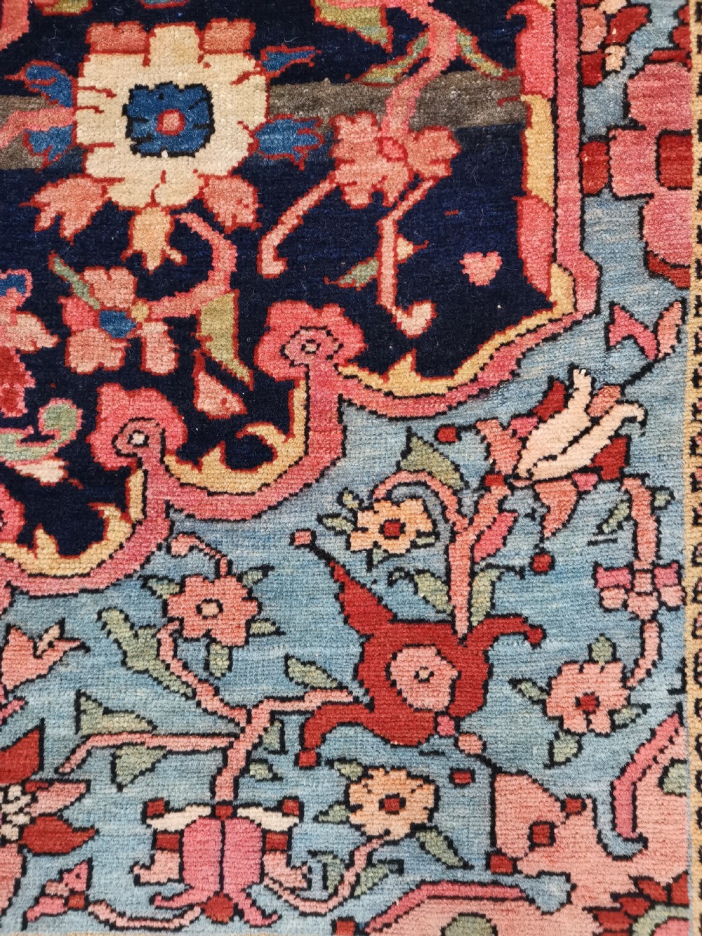 A hand-knotted antique Persian Mishan Malayer wool rug with a navy blue field, central olive medallion, and rose pink floral borders. View V